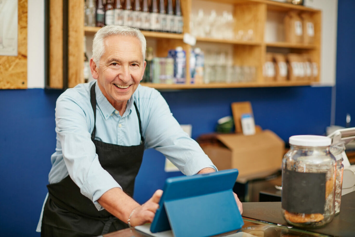 Shot of a senior man working in a coffee shop.