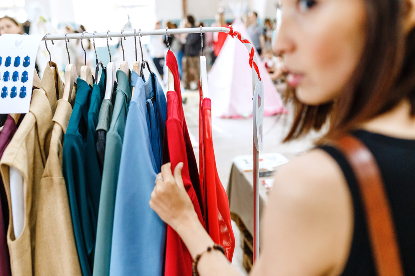 Young woman looking aside while shopping clothes