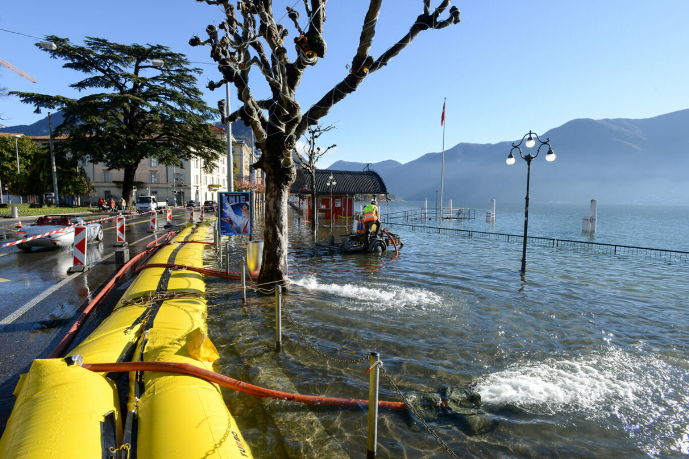 Lugano, Switzerland - 18 November 2014: People of civil Protection pumping water of the inundation of lake Lugano on Switzerland