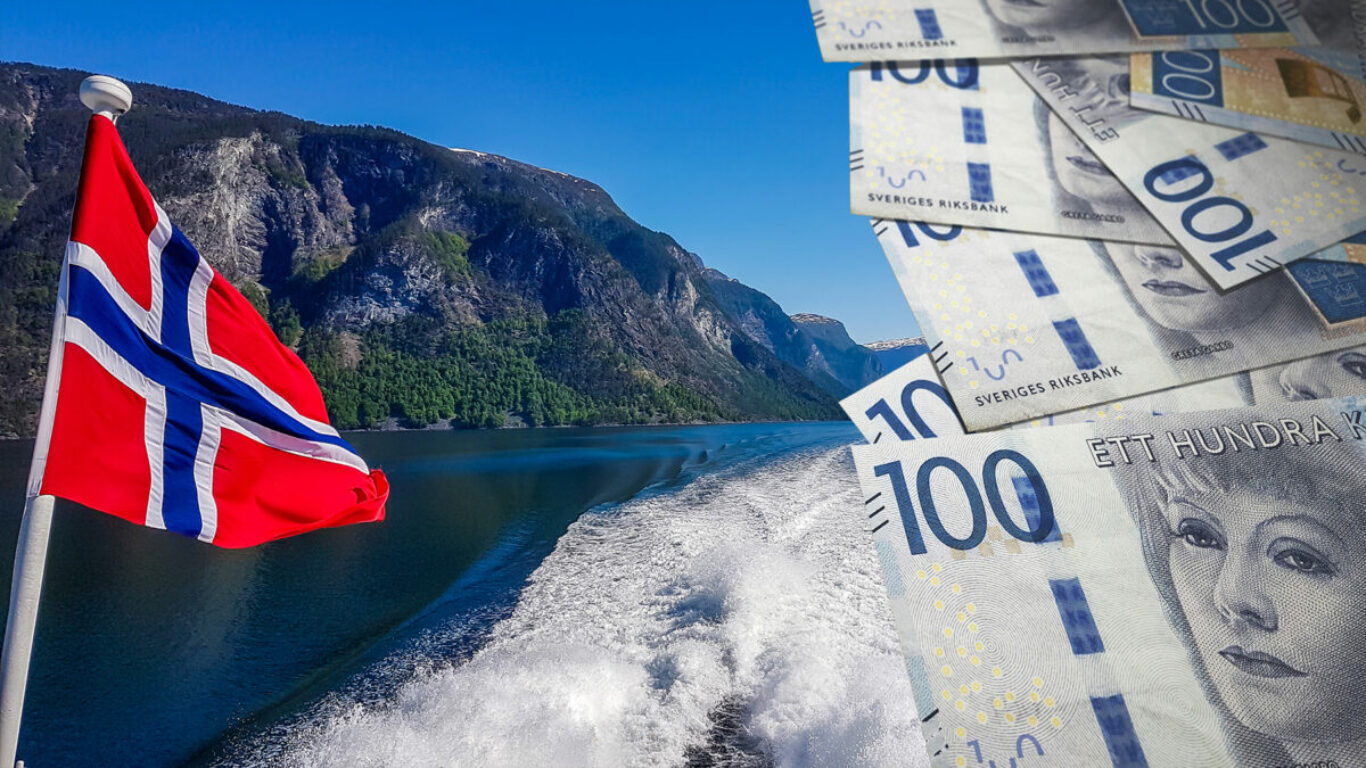 Norwegian flag hanging on  the railing of the ship and waving above the water.The motor of the ship makes the water wavy and foamy. Tall, lush green mountains surrounding the fjord. Clear blue sky.
