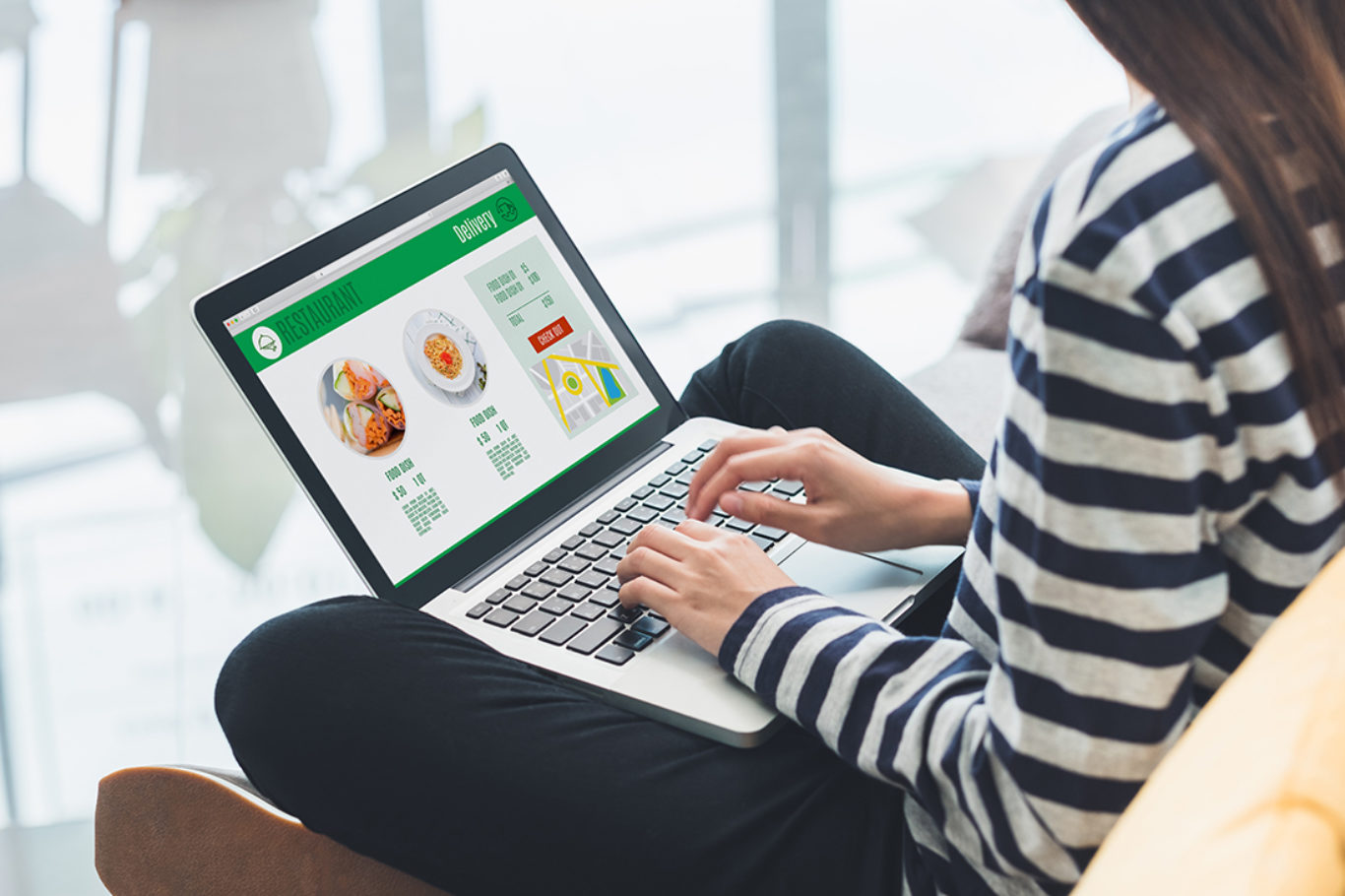 Asian woman cross leg sitting at couch use laptop to order food online in website at home.digital leisure convenient lifestyle.Food and drink business concept
